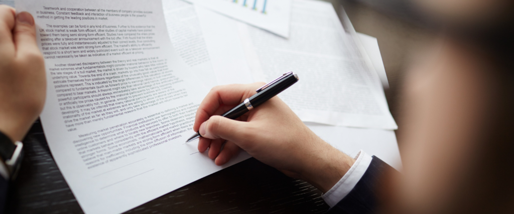 Professional signing a web development contract outlining client protection, project scope, ownership rights, and payment terms.