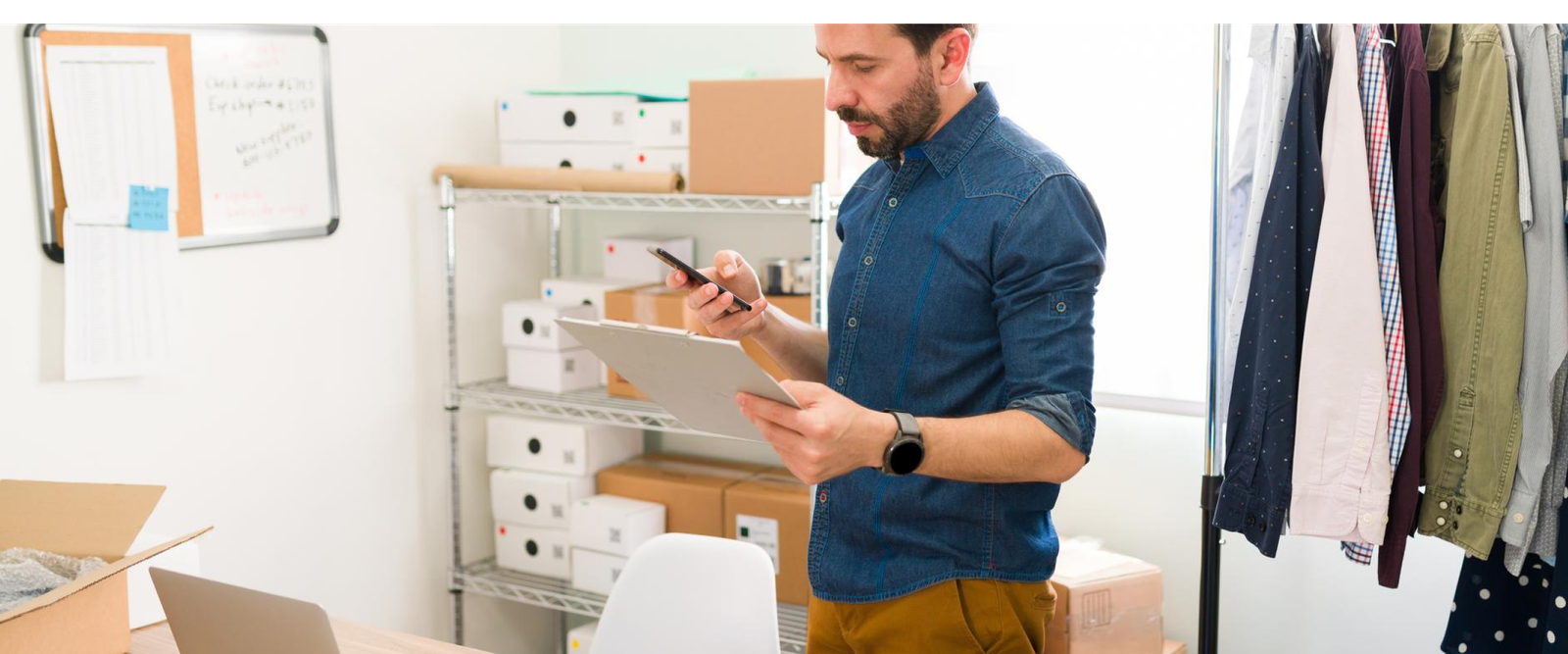 Small business owner managing inventory while using SEO strategies to grow local business online.
