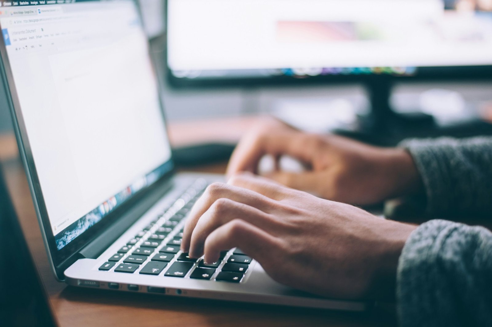 Entrepreneur researching e-commerce website costs on a laptop